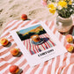 Cortado – Spanish Hilltop Table Scene, Spanish Coffee Wall Decor, unframed on coastal sand